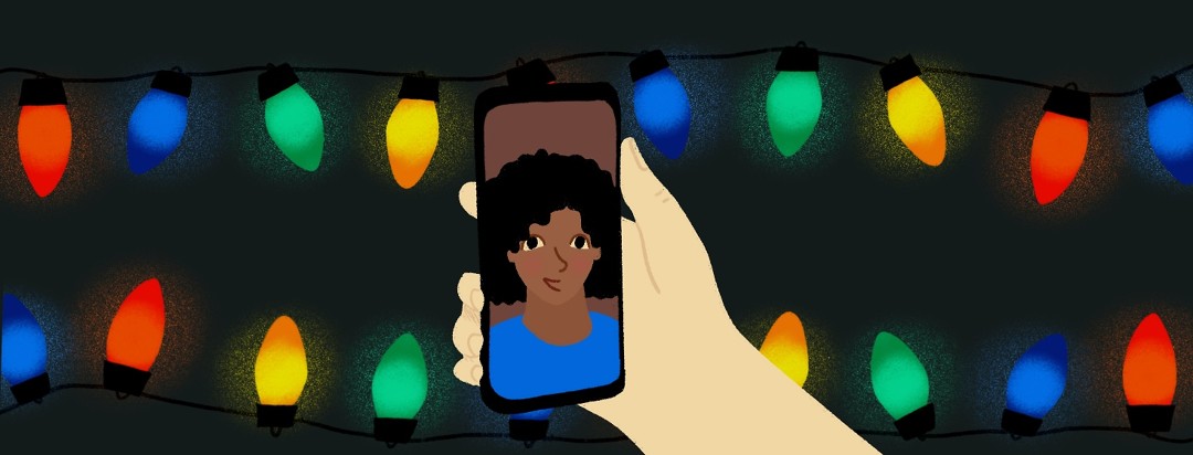 Two people talk on a video call with Christmas lights in the background