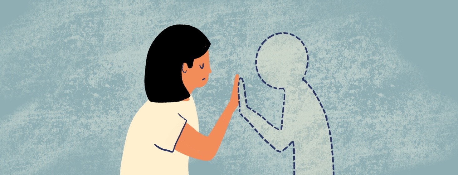 A woman reaches out to touch a person who isn't there