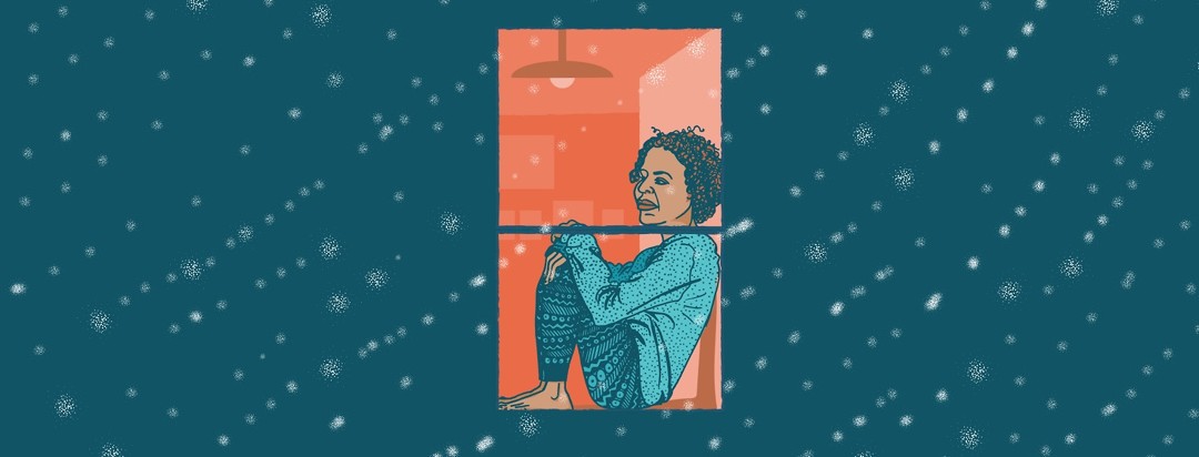 A woman sits alone in a window and watches snow fall outside