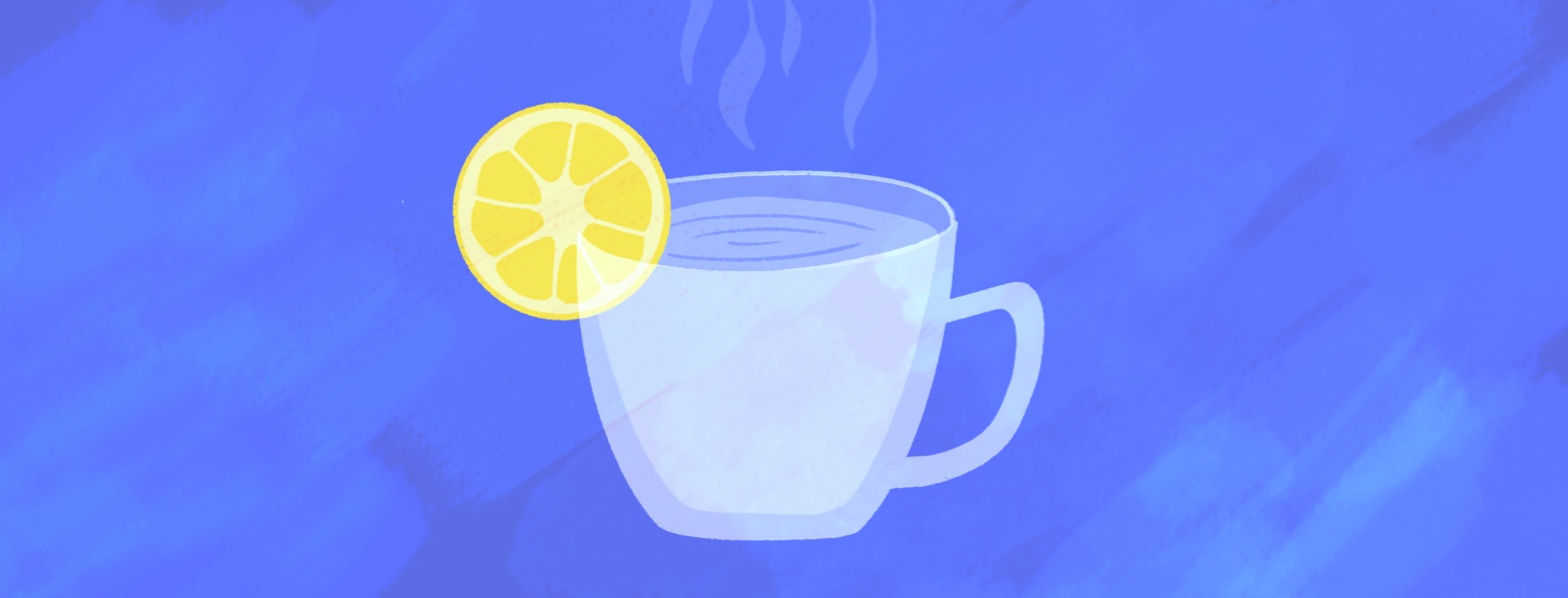 A mug of steaming hot water with a lemon wedge