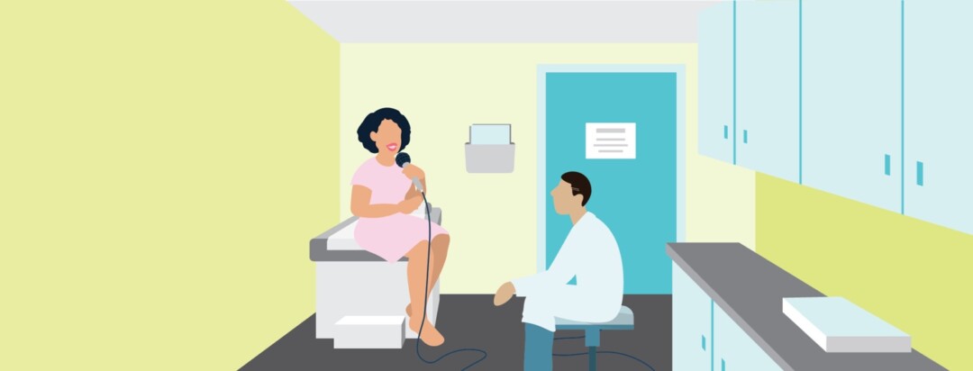 A woman sitting on a doctor's exam table speaks confidently into a microphone as an adult male doctor sits in a chair and listens