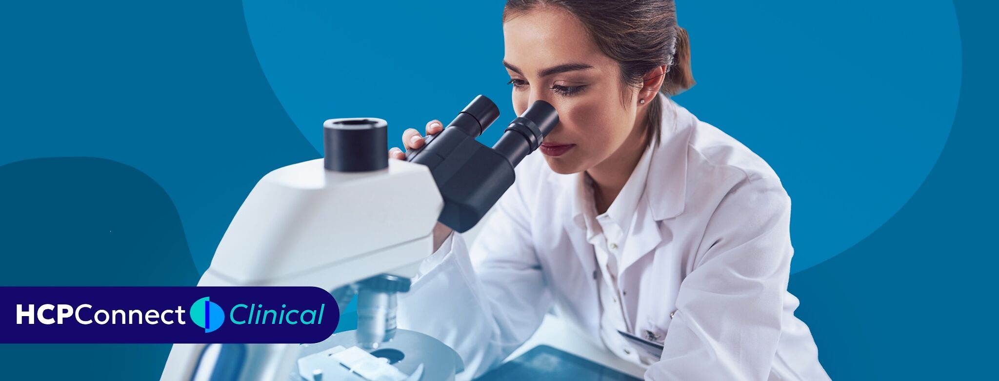 A doctor looks through a microscope